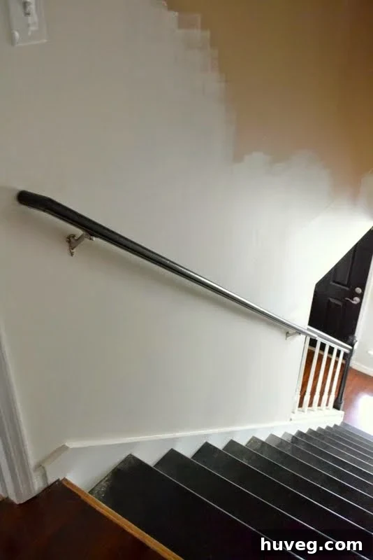 View of the freshly installed black stair handrail, showcasing the completed project