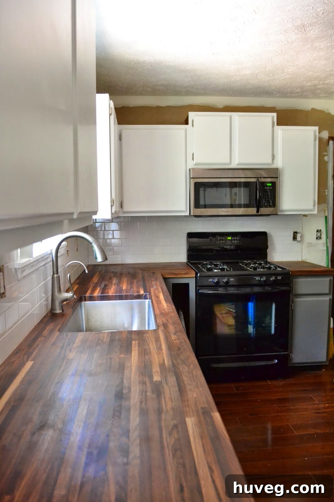 Newly installed upper kitchen cabinet doors, showcasing the progress of a DIY kitchen renovation.