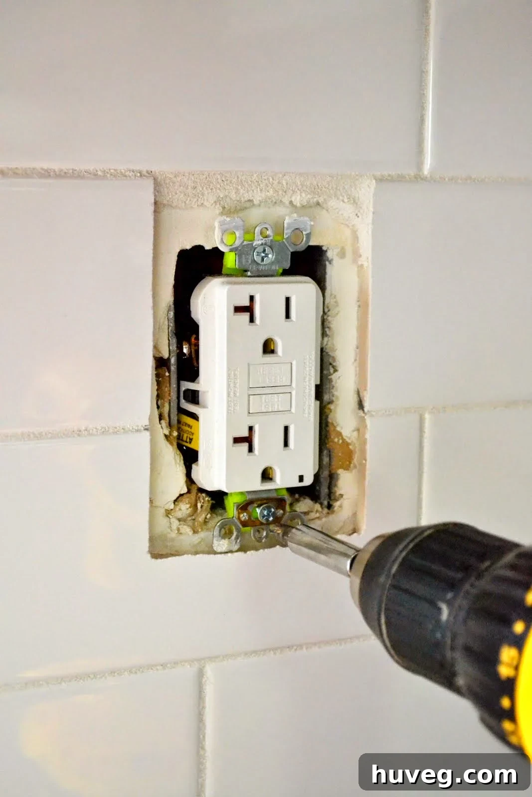 Screwing the outlet in place