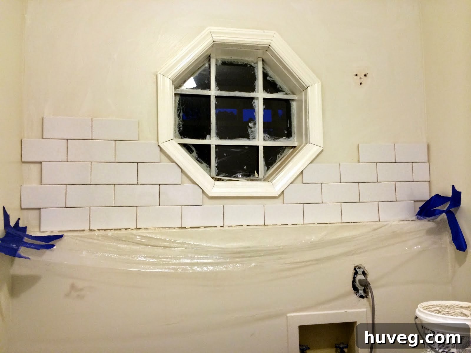 Stunning DIY tile backsplash in a laundry room, transforming the space with elegance and durability