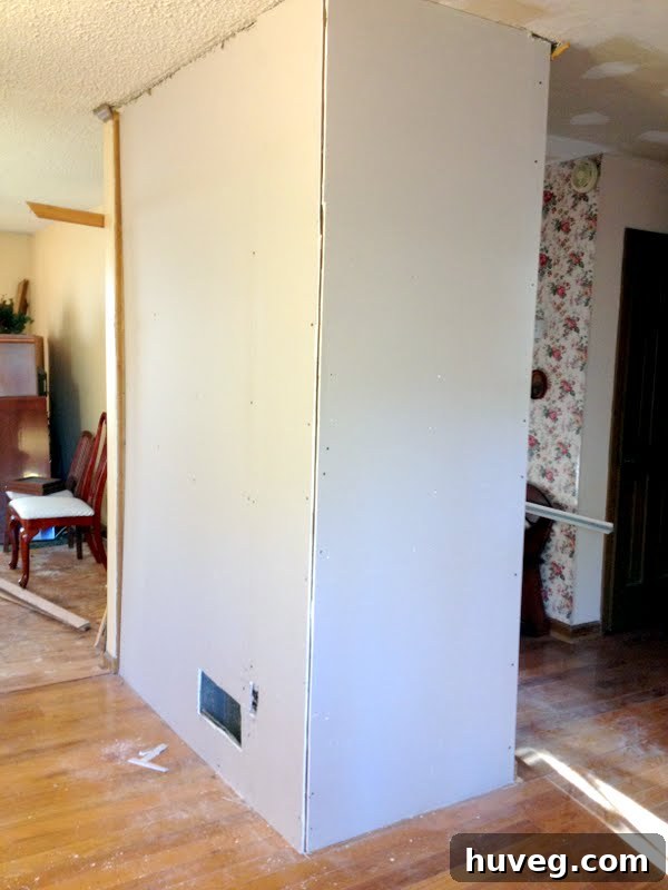 Dining room with newly installed drywall, ready for finishing