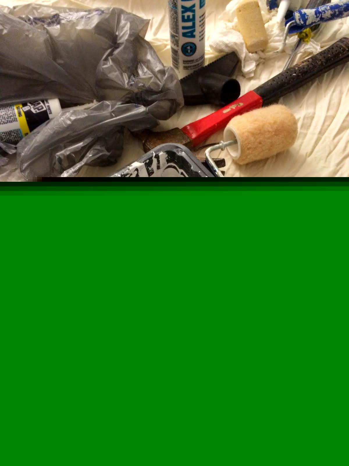A paint tray with a roller, ready to apply primer or paint to the walls