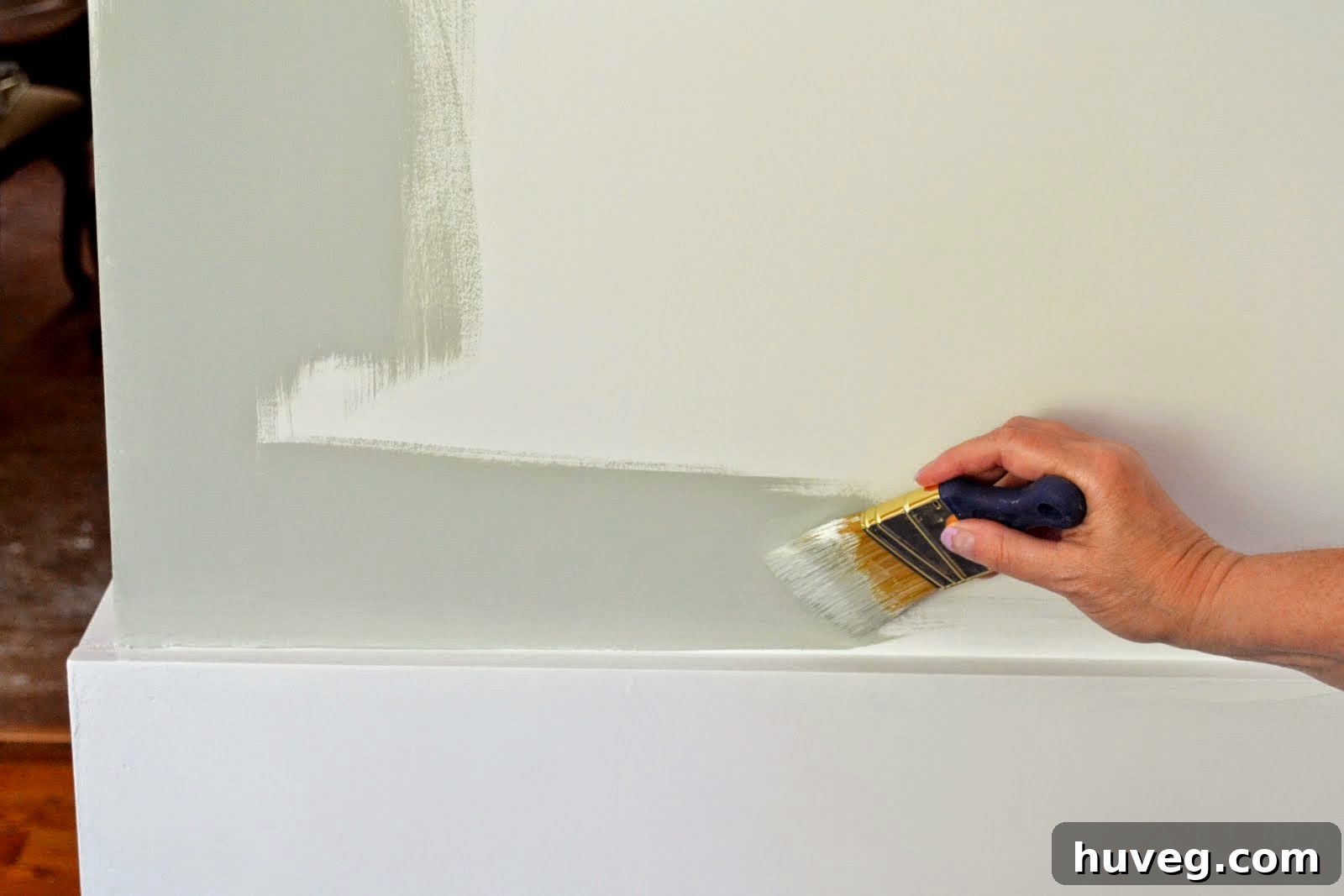 Careful painting technique, cutting in along the edges of the wall to ensure clean lines