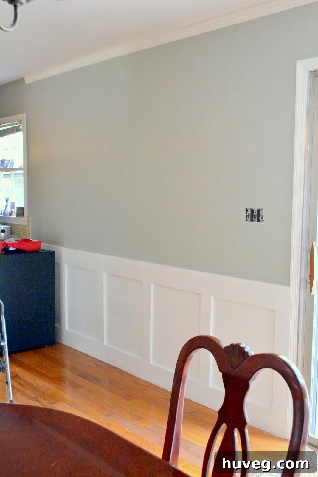 Close-up of the elegant gray painted wall and crisp white wainscoting in the dining room
