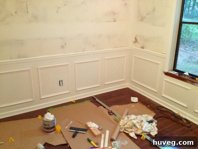 Preparing the dining room walls for painting, showing picture frame molding installed.