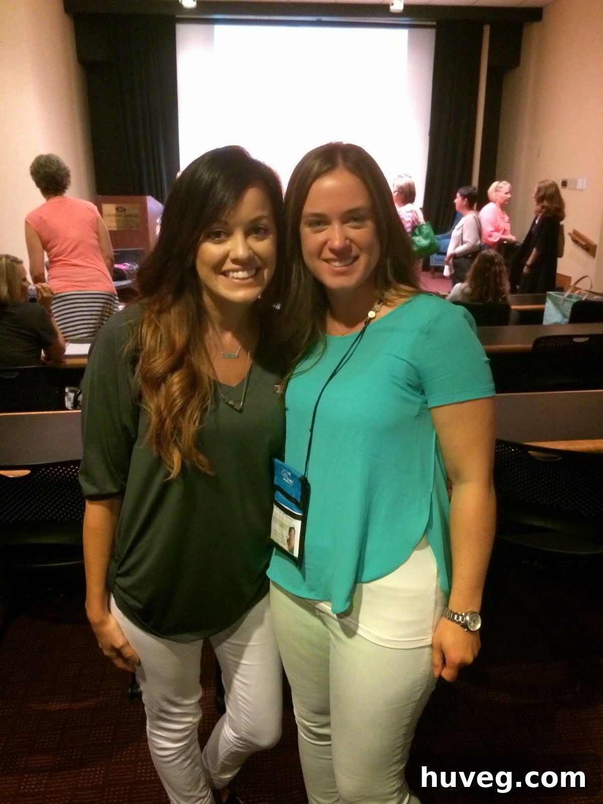 A candid photo of Sarah and Liz sharing a laugh at the Haven Conference, highlighting friendly interactions.