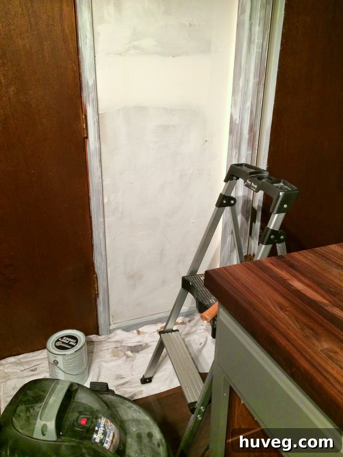 Detail of a kitchen wall section being prepared for painting and skim coating