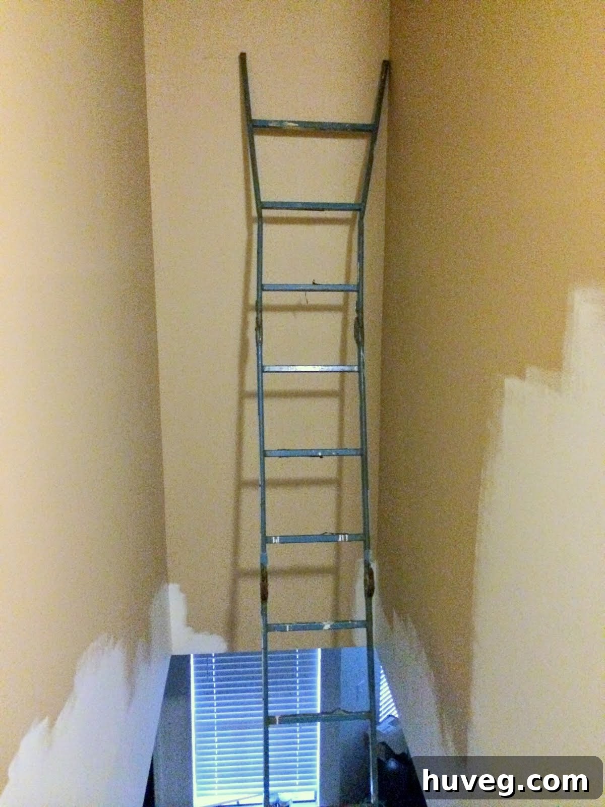 Multi-fold ladder fully extended against a wall