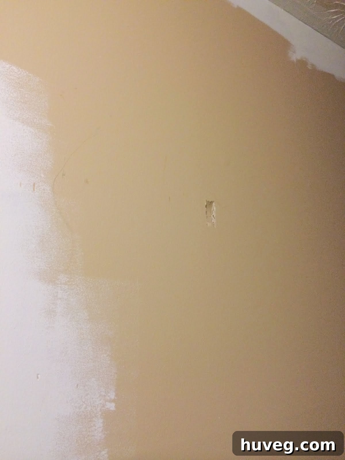 Accidental drywall dent caused by ladder