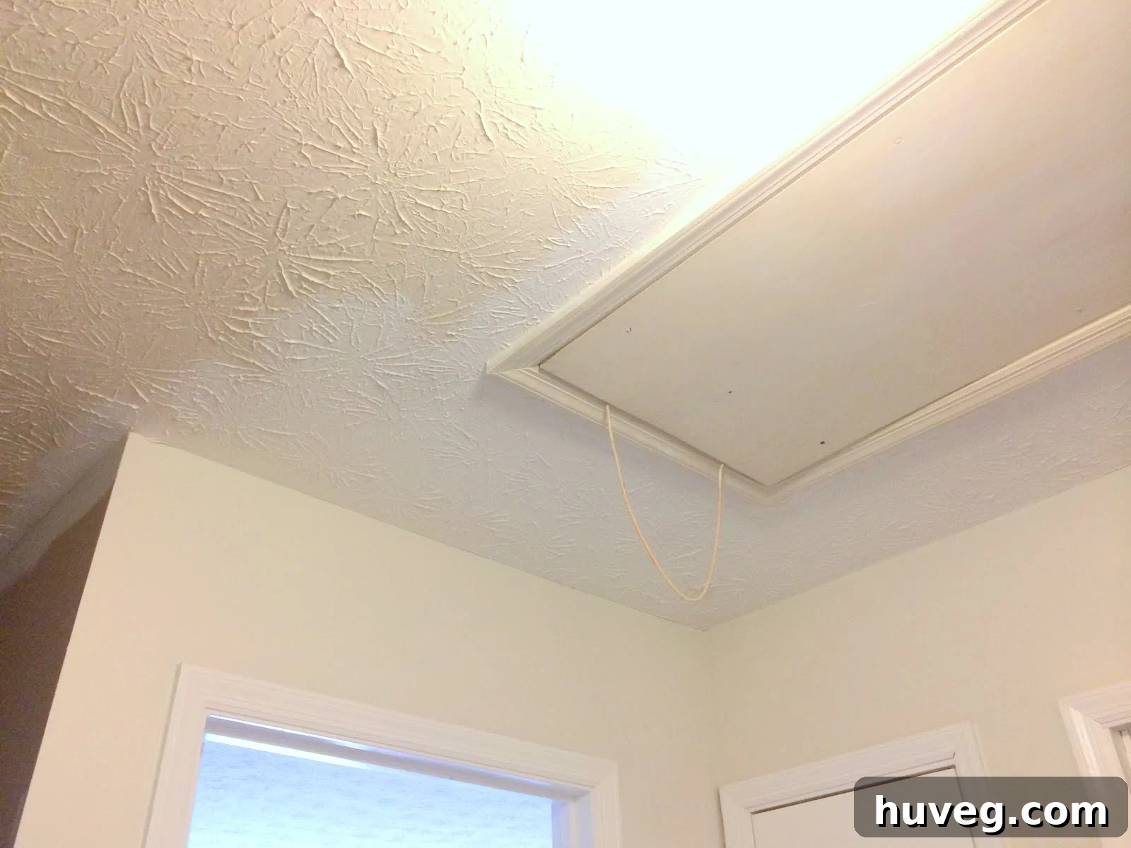 Newly painted hallway ceiling reflecting light