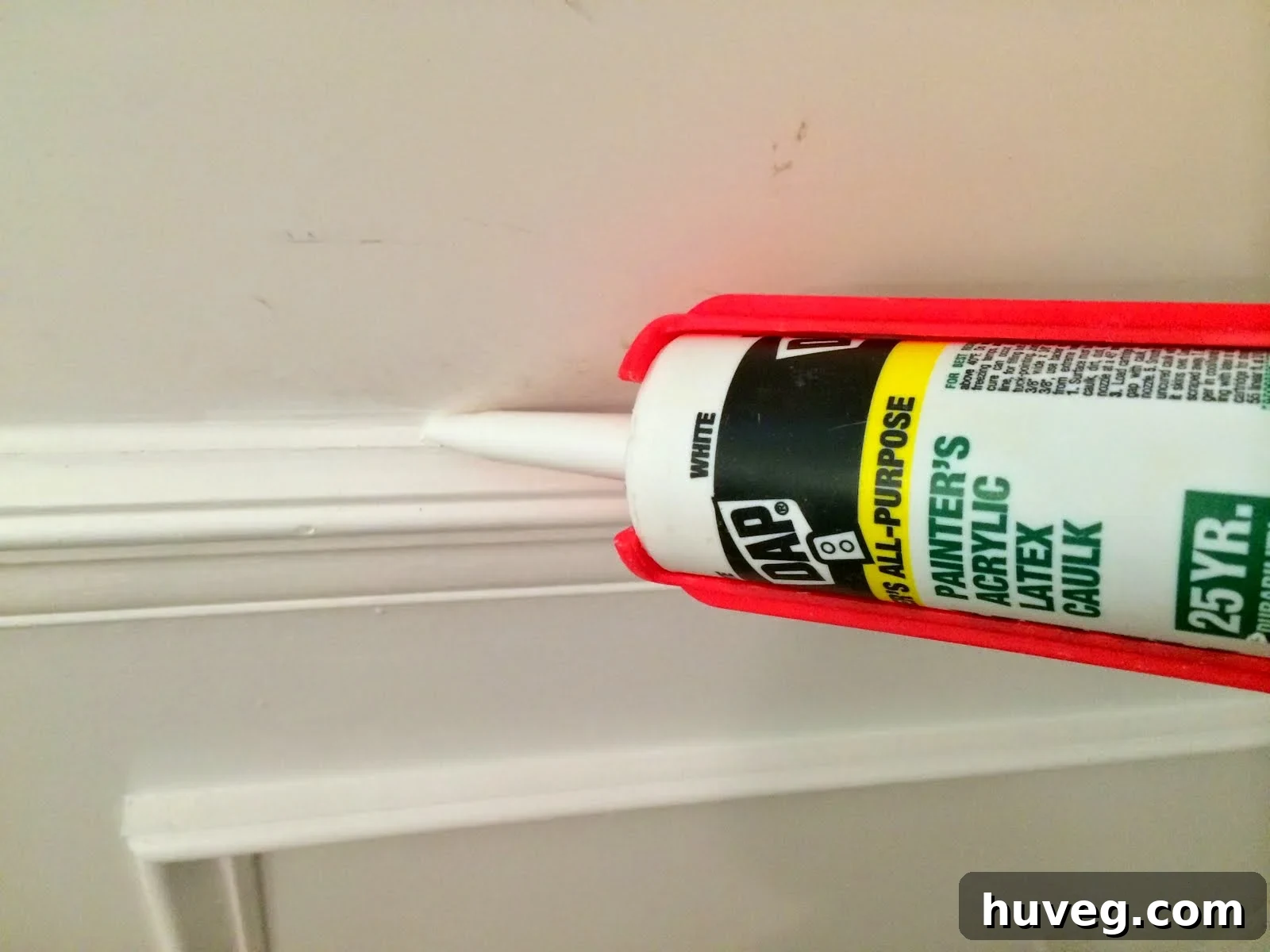 DAP Painter's Caulk being applied neatly along trim for a clean seam