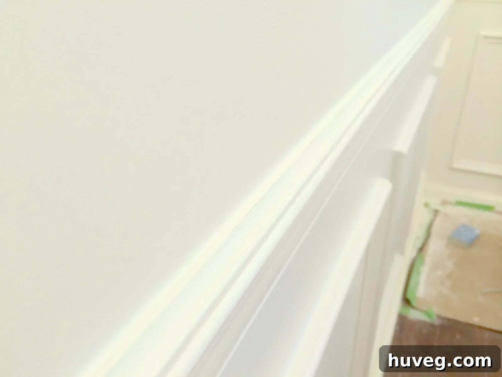 Close-up of wainscoting with freshly cleaned and prepped trim, awaiting final paint