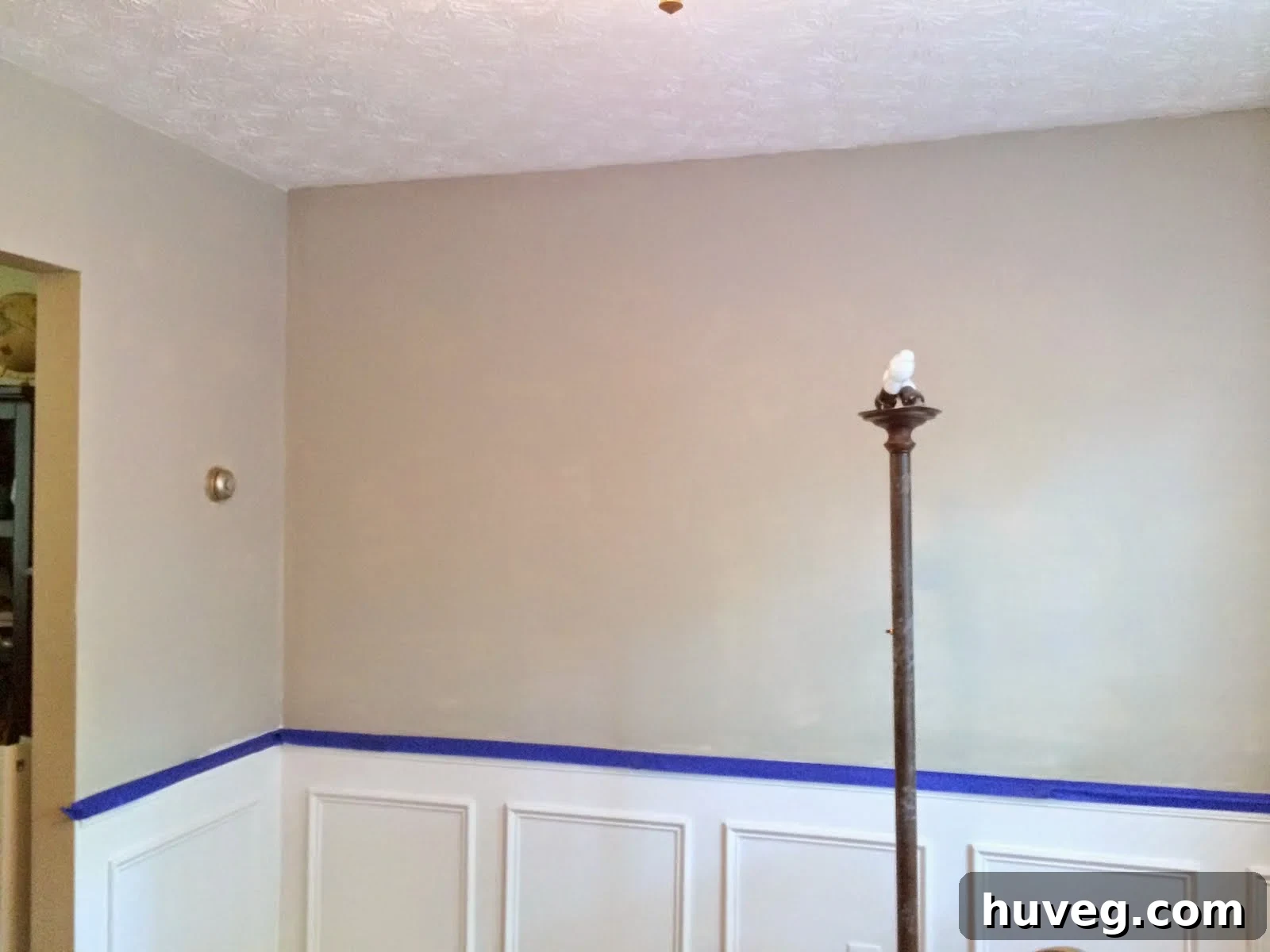 Wall with decorative trim meticulously taped off before primer application
