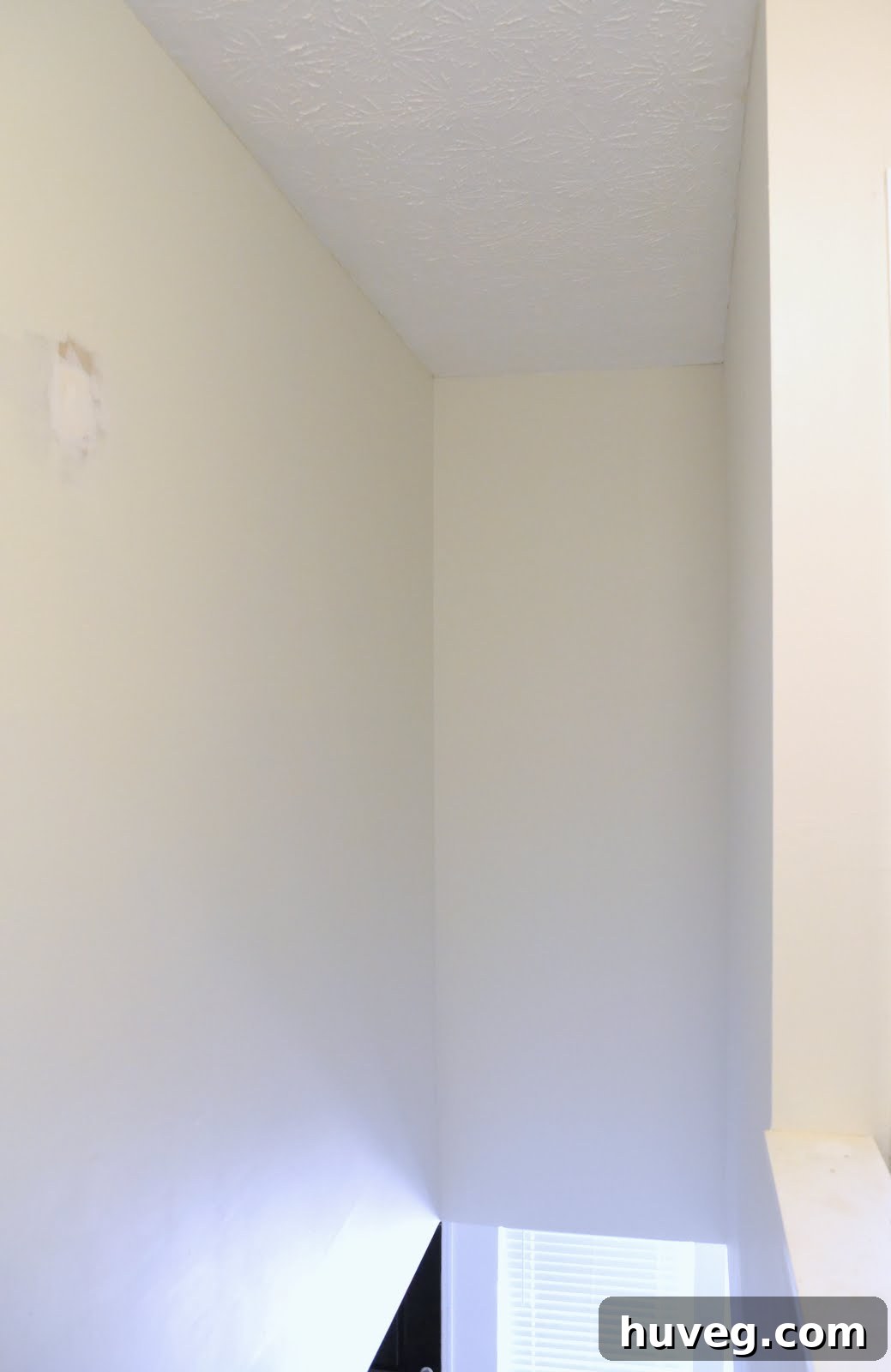 Hallway wall with visible patching spots after painting