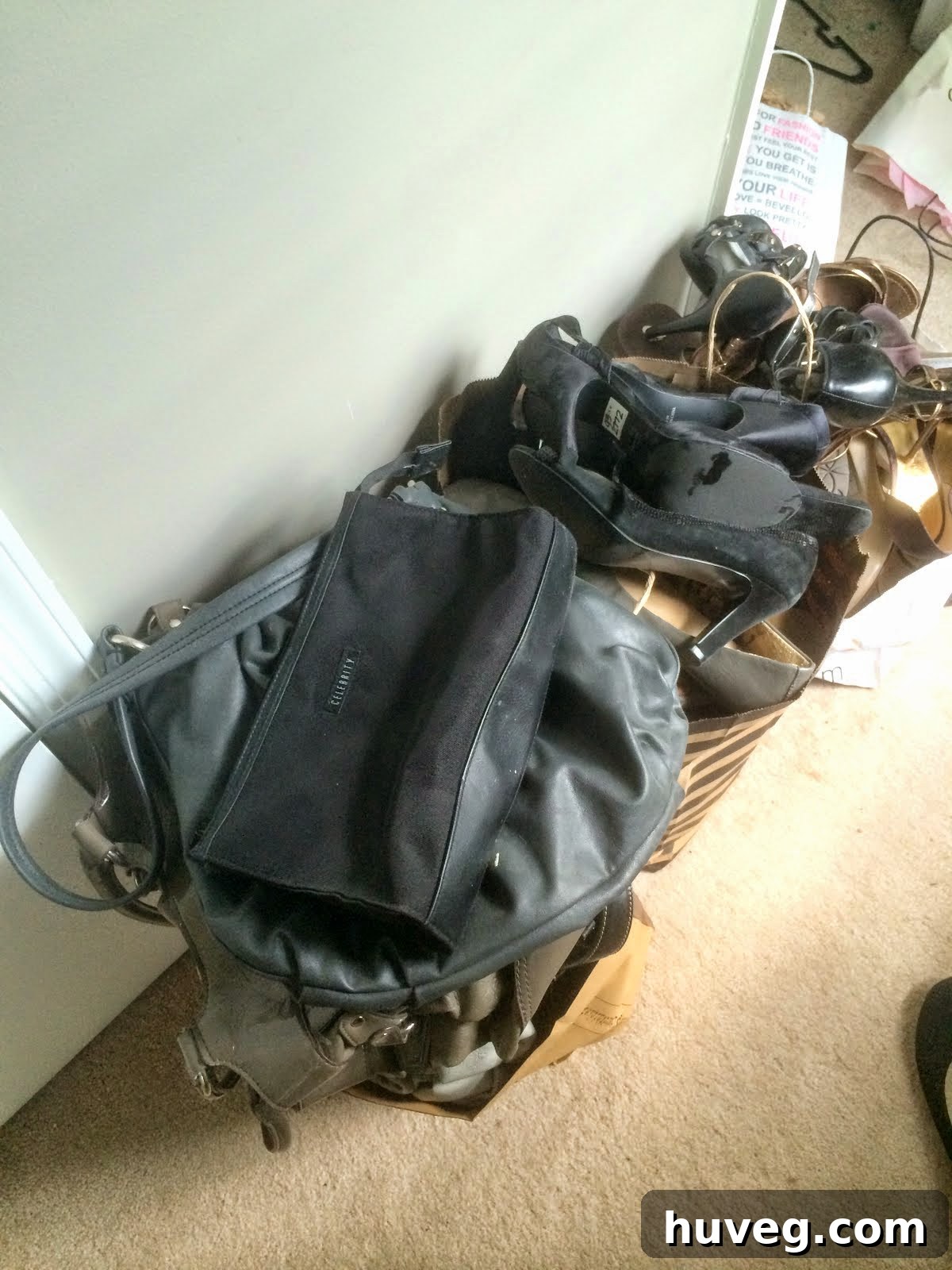 Pile of old shoes and handbags to be donated during a decluttering session.