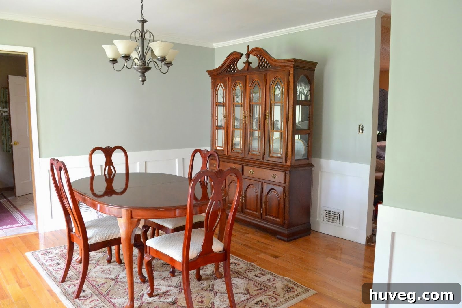 Completed dining room makeover with new drywall, wainscoting, and fresh paint
