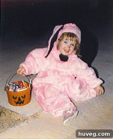 Pink bunny in a Halloween costume, ready to collect candy