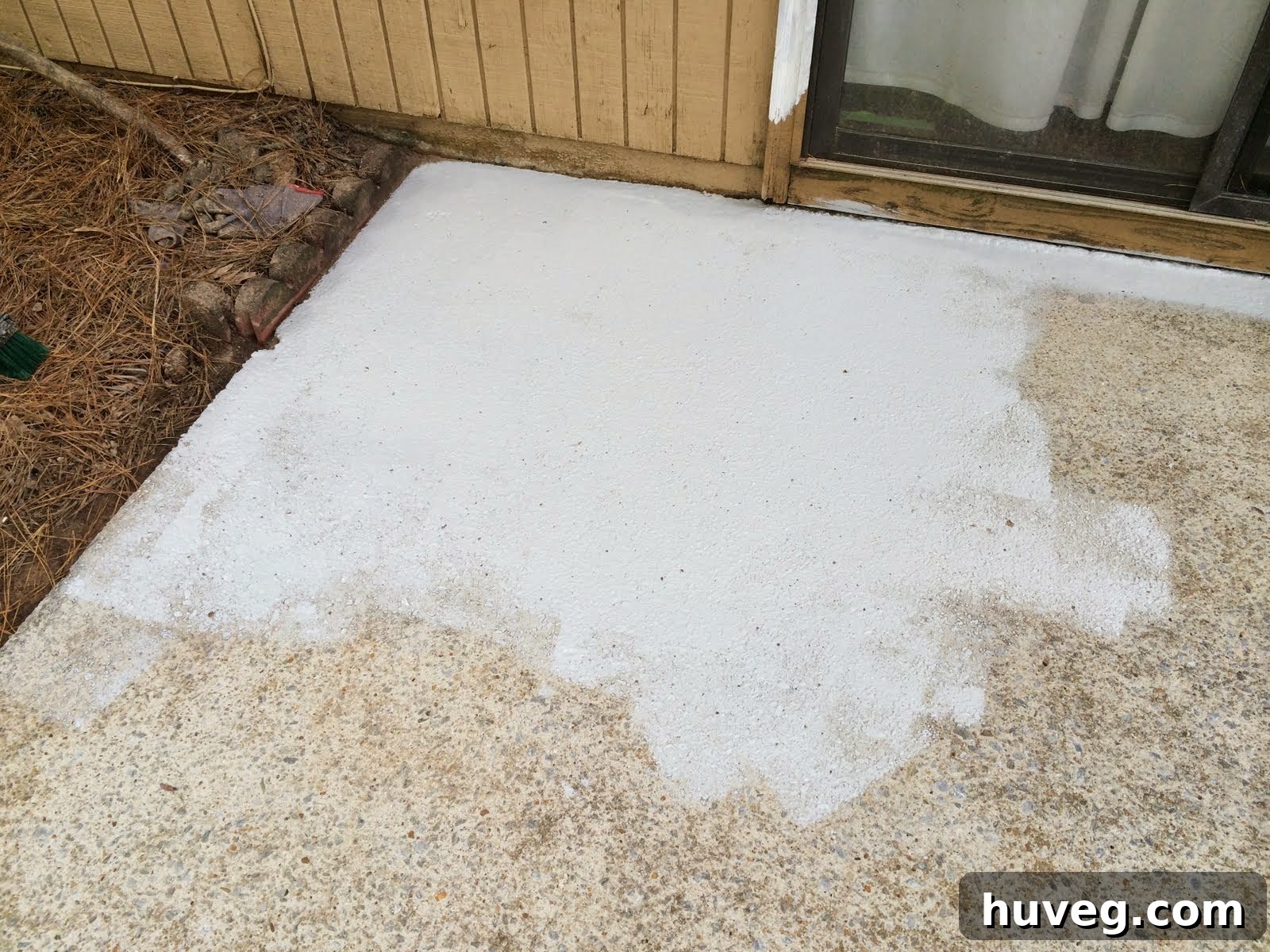 First corner of the patio being painted with concrete resurfacer