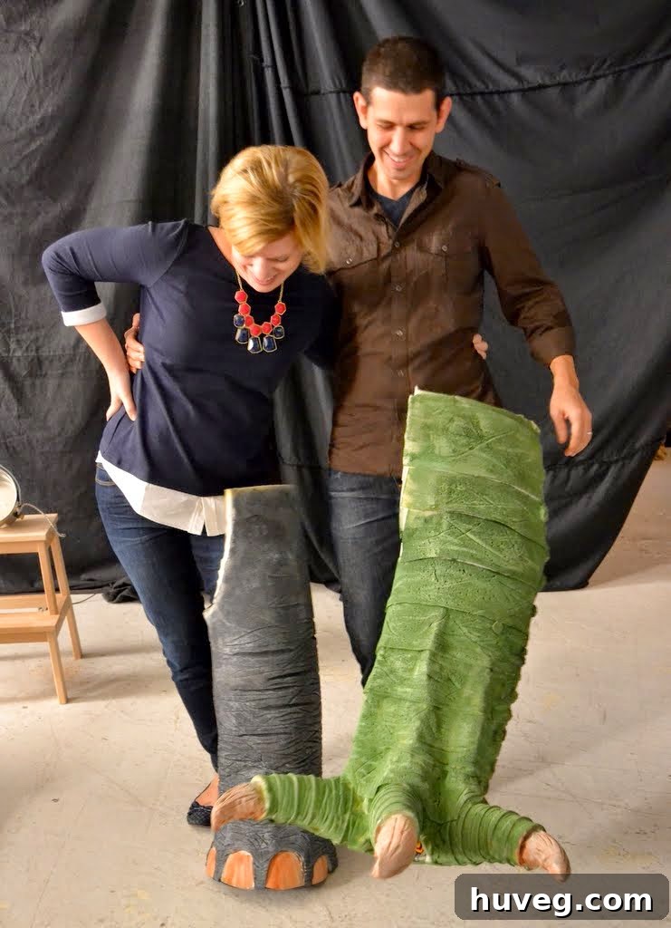 Wendy and Alex standing in elephant and dino leg