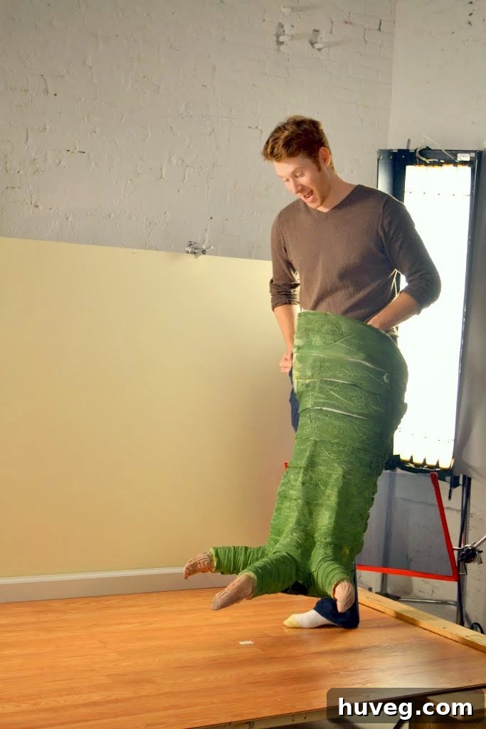 Man on stage in a giant lizard leg