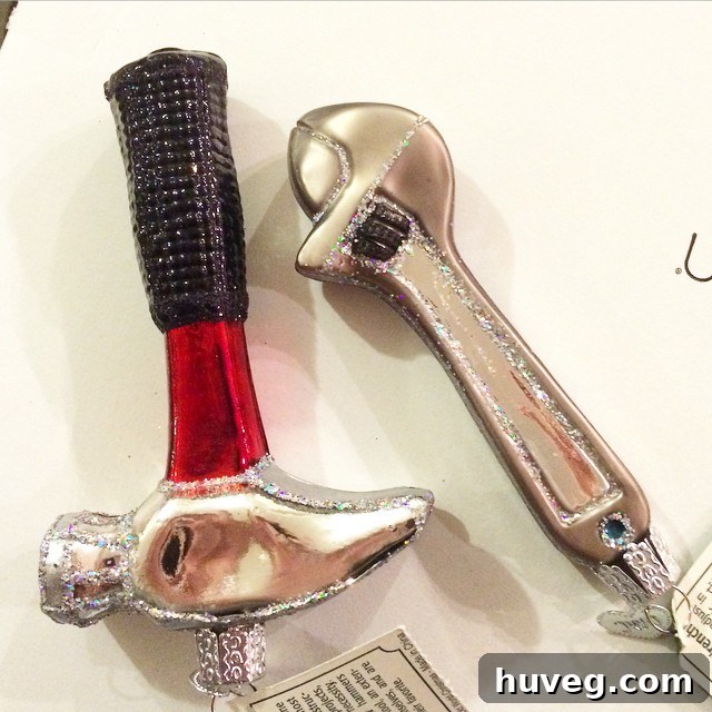 Two intricately designed Christmas ornaments shaped like a claw hammer and a wrench, showcasing tool-themed holiday decor.