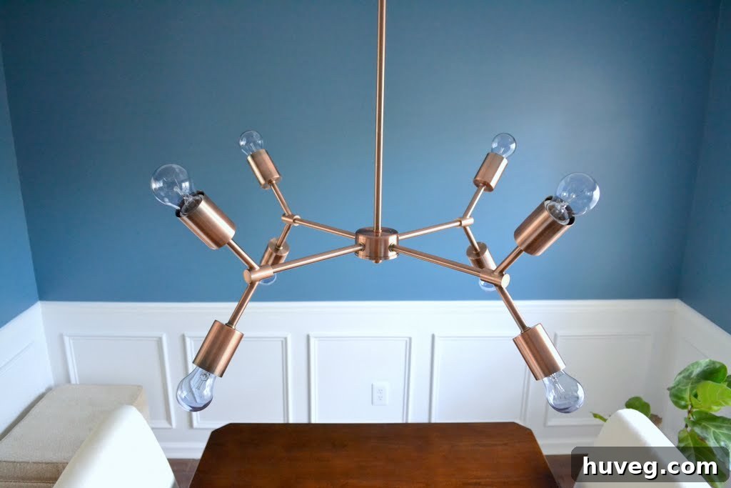 Another perspective of the copper chandelier, highlighting its multi-arm design and reflective qualities