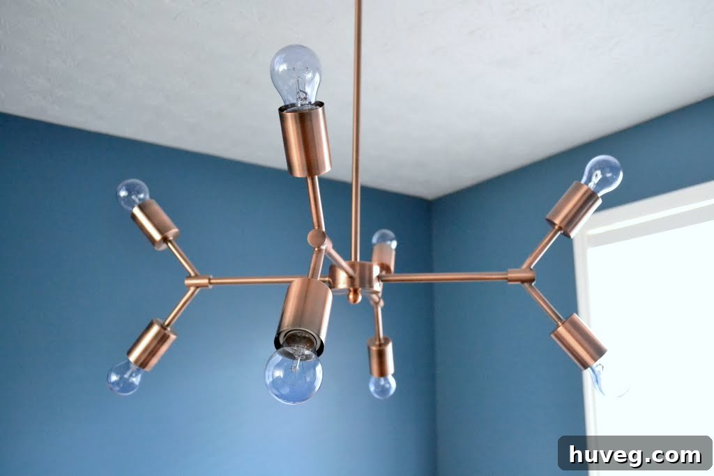 Detailed shot of the copper chandelier's arms and light sockets, ready for bulbs