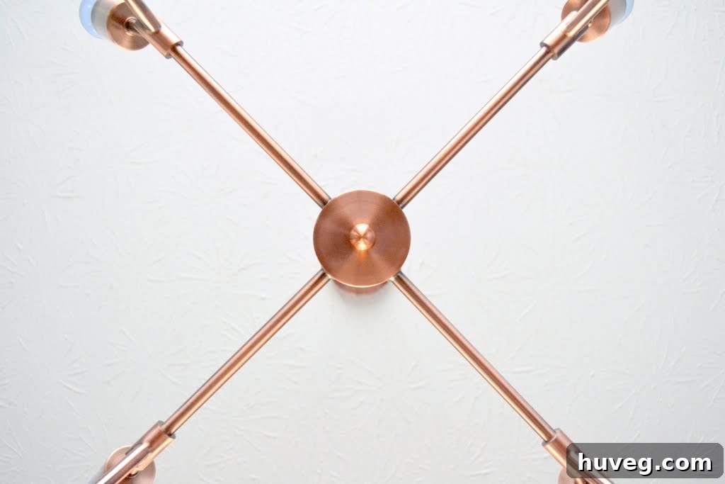 Wide shot of the dining room showcasing the newly installed copper light fixture and the overall decor