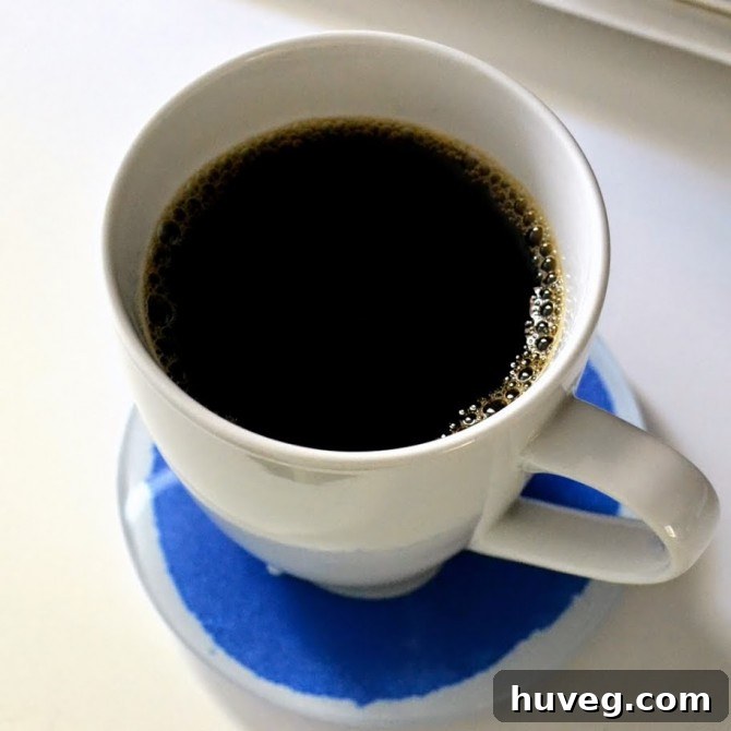 A warm cup of coffee steaming, symbolizing a moment of peace and reflection amidst a busy schedule.