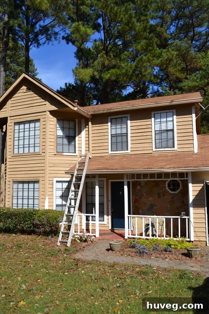 House exterior in 2012 after some painting and minor repairs, showing improvement.