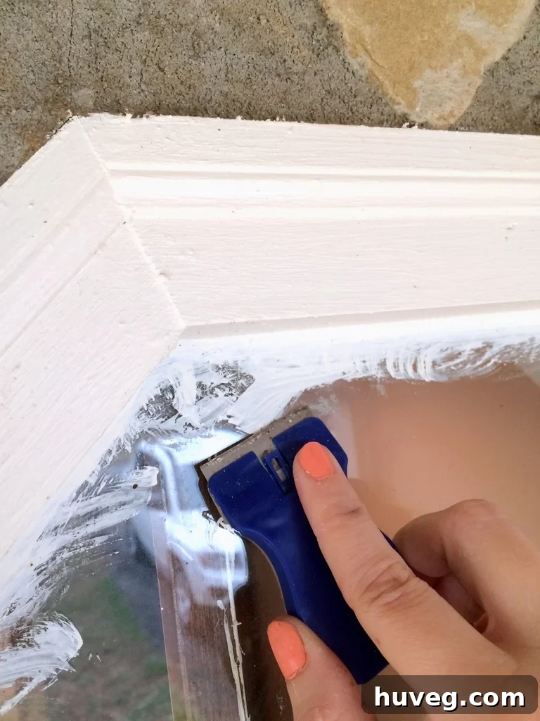 How to remove paint from windows with a scraper