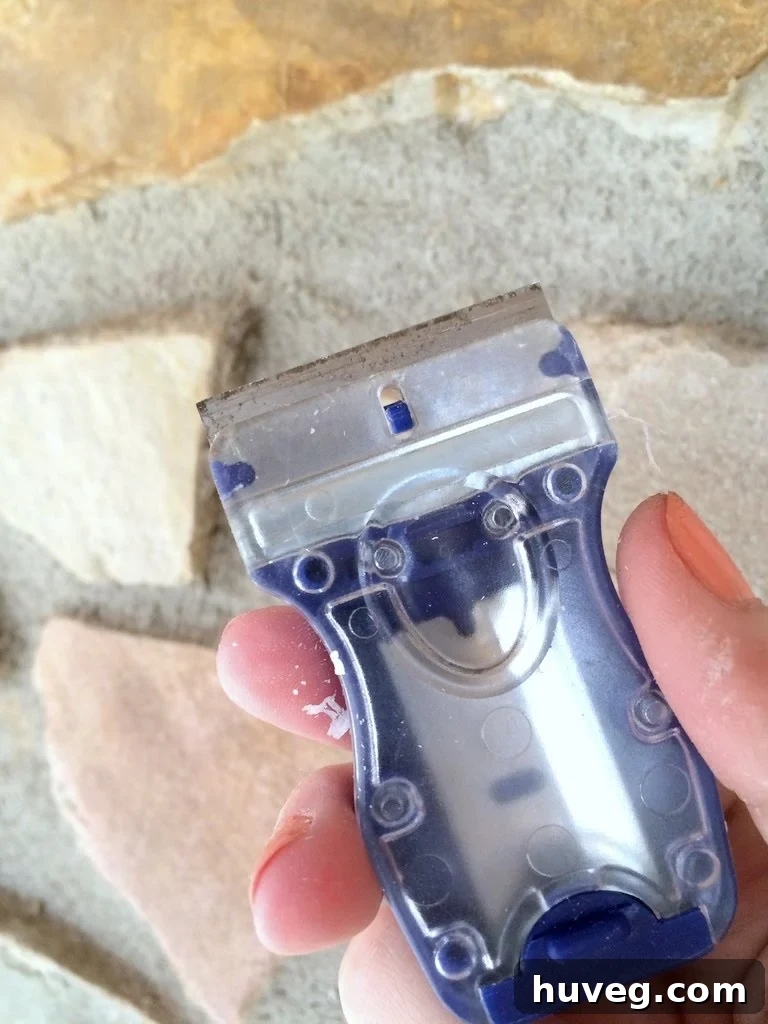 Detail shot of using a glass scraper on a window