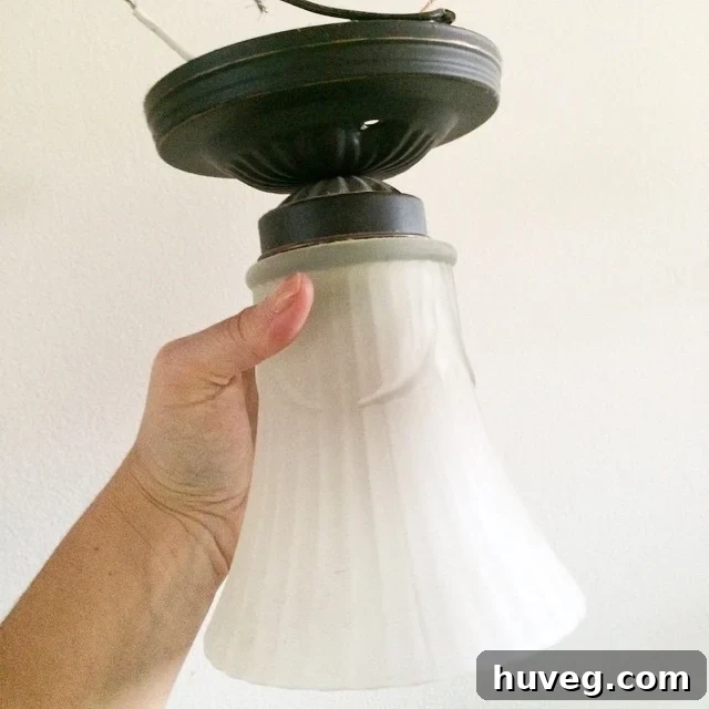 Old light fixture in laundry room before renovation