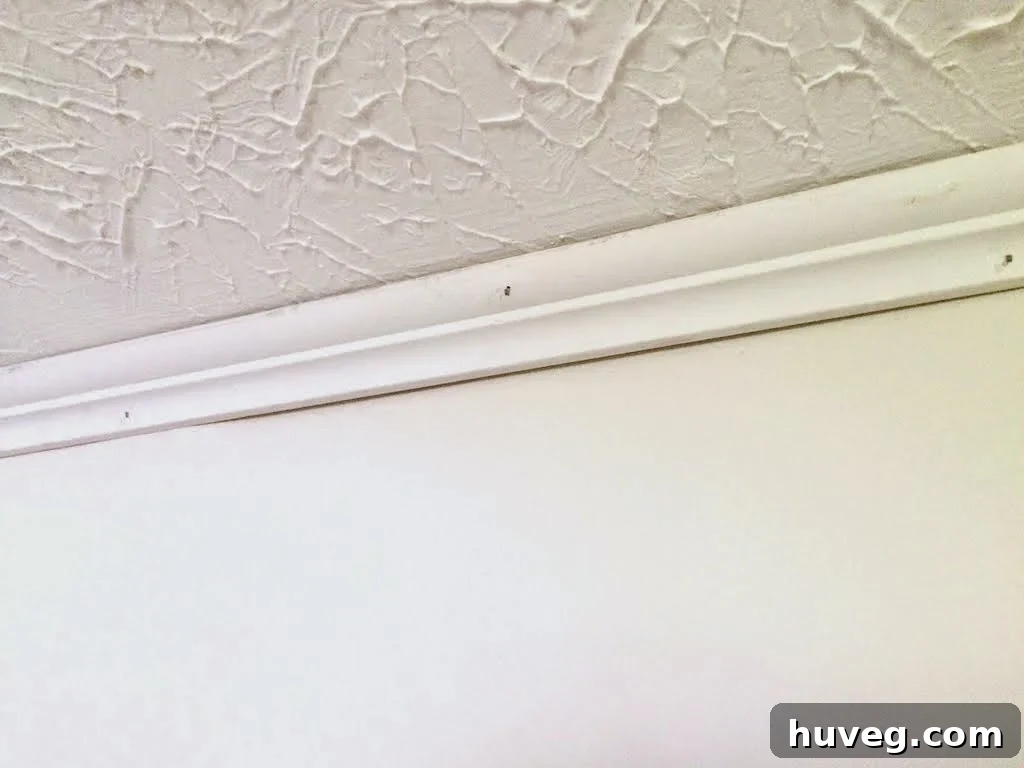 Blue painter's tape showing shelf height options in laundry room