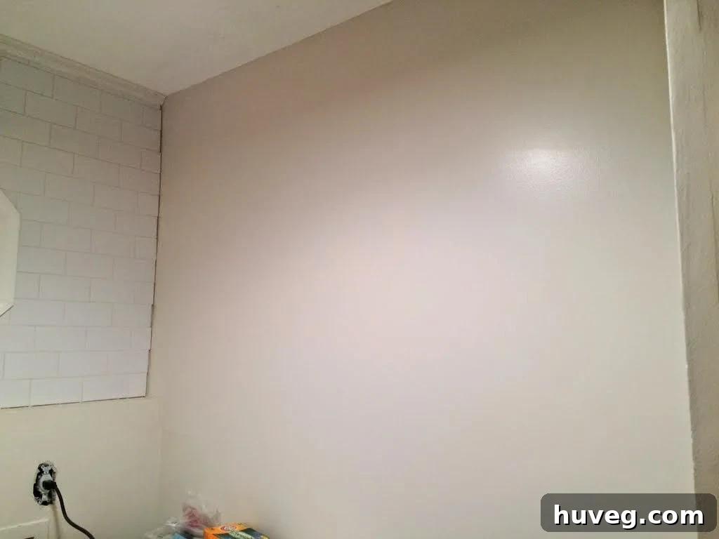 Blue tape outlining potential shelf configuration in L-shaped laundry room