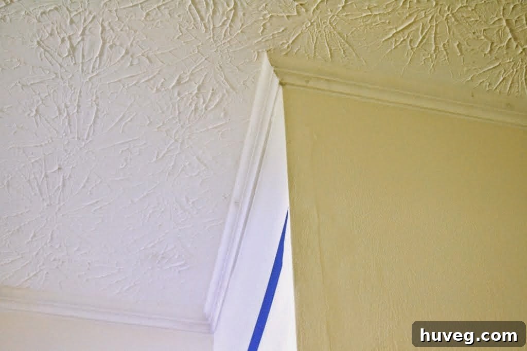 Crown Molding Seams Being Patched and Caulked