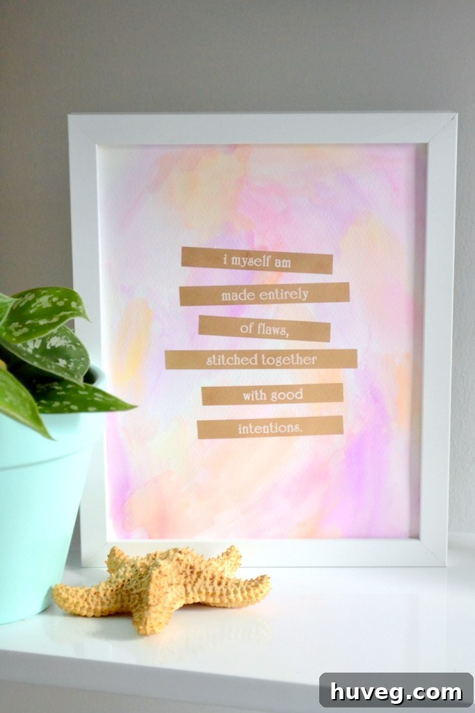 Framed gold foil quote art displayed with green plants.
