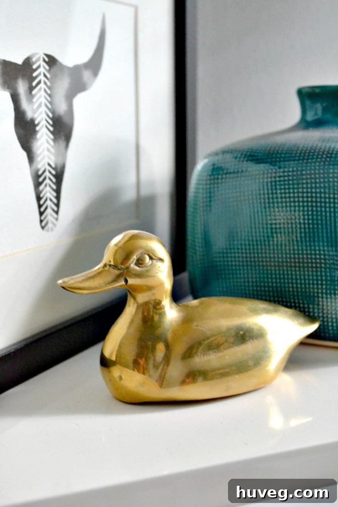 A charming brass duck paperweight, the first piece in an unexpected collection, sits gracefully on a desk, showcasing its detailed craftsmanship and warm metallic sheen.