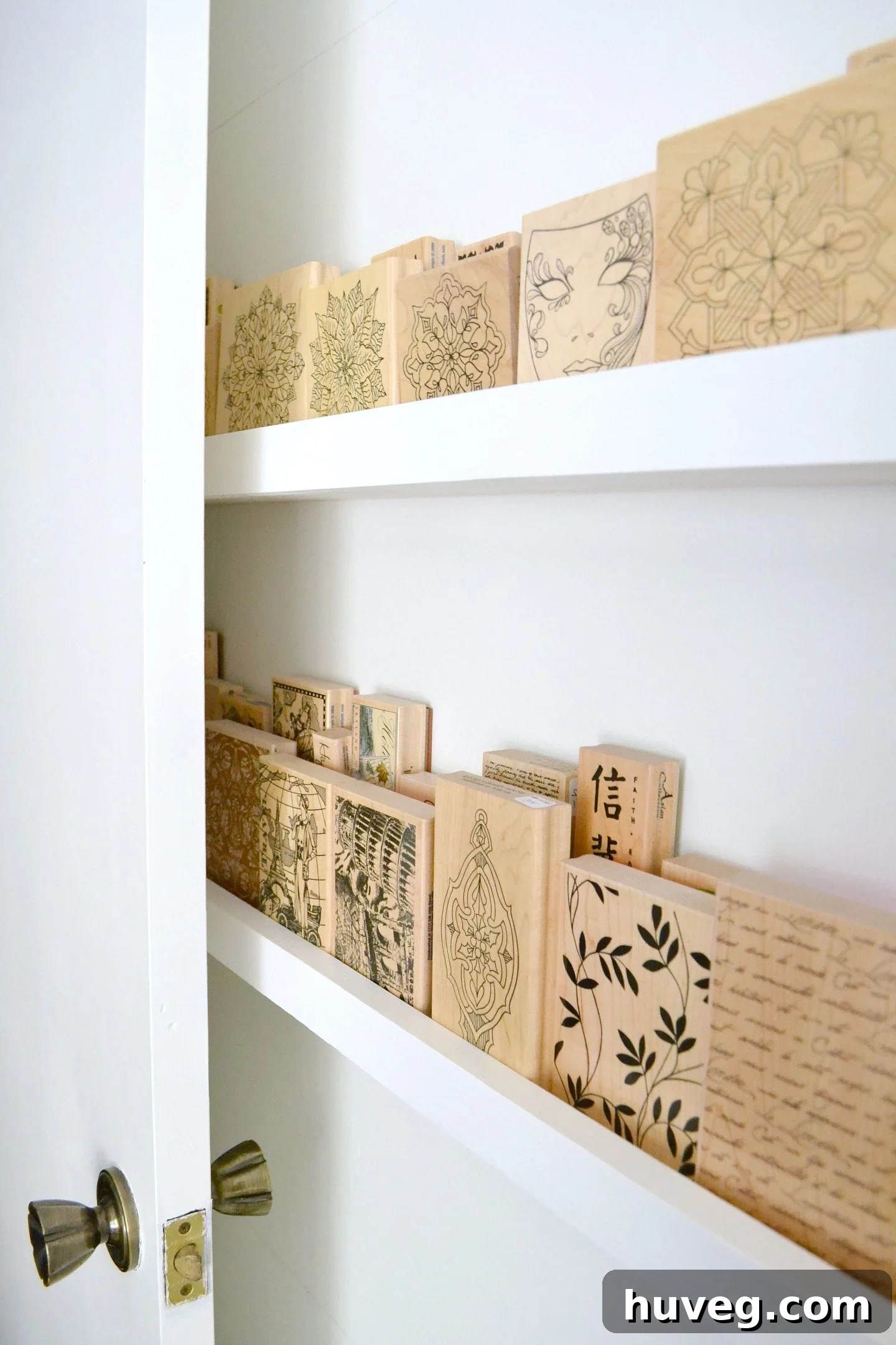 Completed DIY wood stamp storage ledges behind a door, showcasing vertical wall organization for a home office.