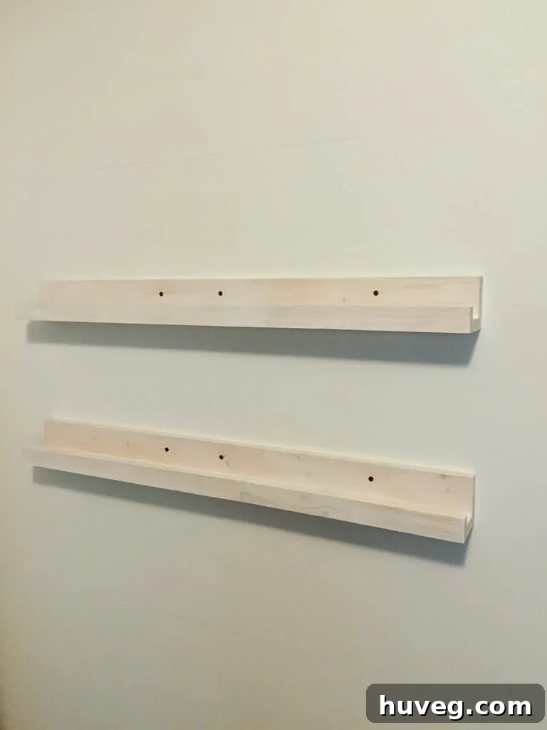 Unpainted DIY narrow storage shelves installed behind a door, showcasing the potential for vertical organization.