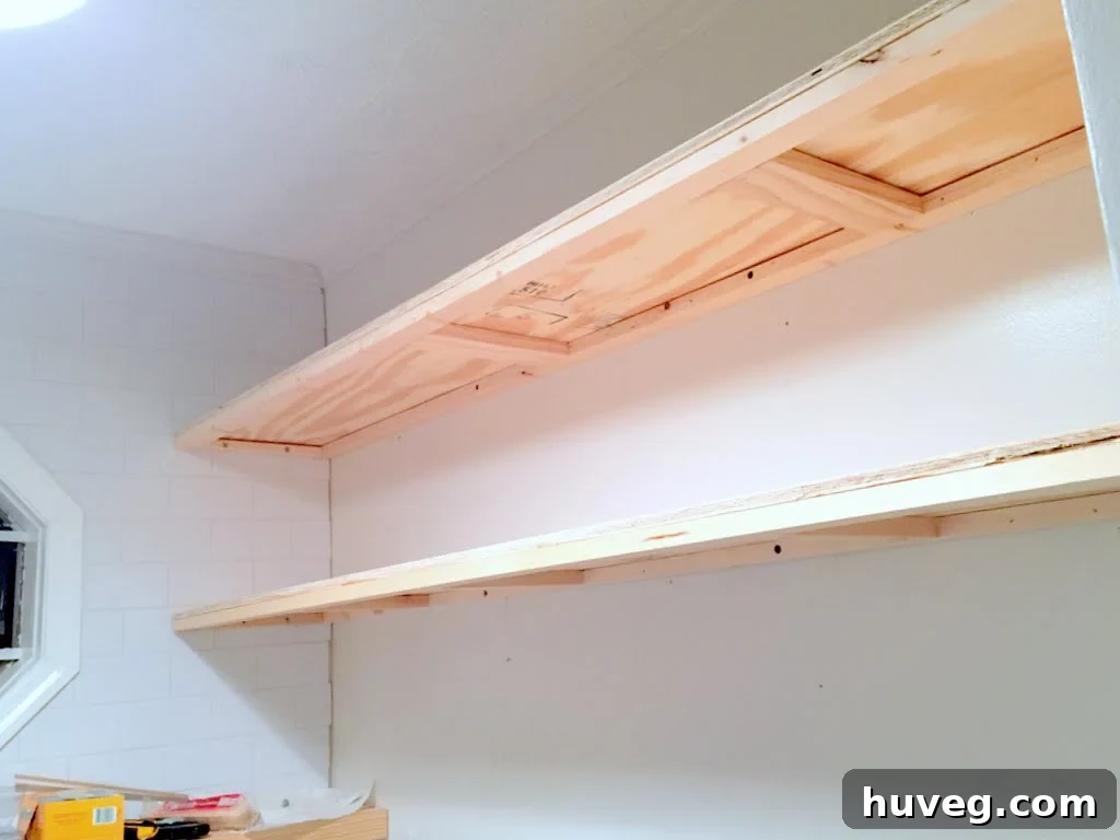 Applying wood glue to floating shelf frame before plywood