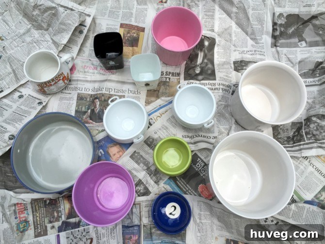 Selection of ceramic pots, separated into groups for drilling or keeping intact, for an upcycling project.