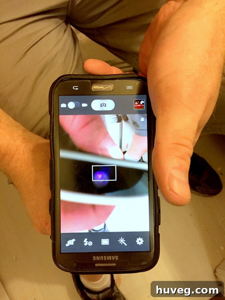 Close-up of a smartphone screen showing infrared light from a remote