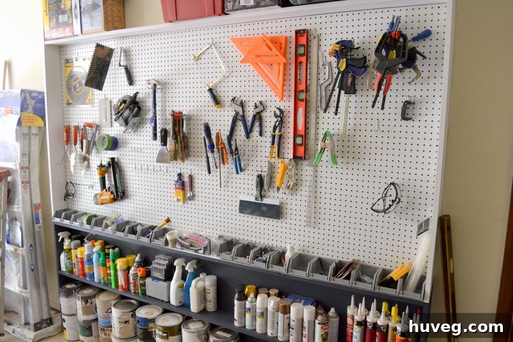 After of pegboard wall, filled with tools and paint, showcasing organized storage