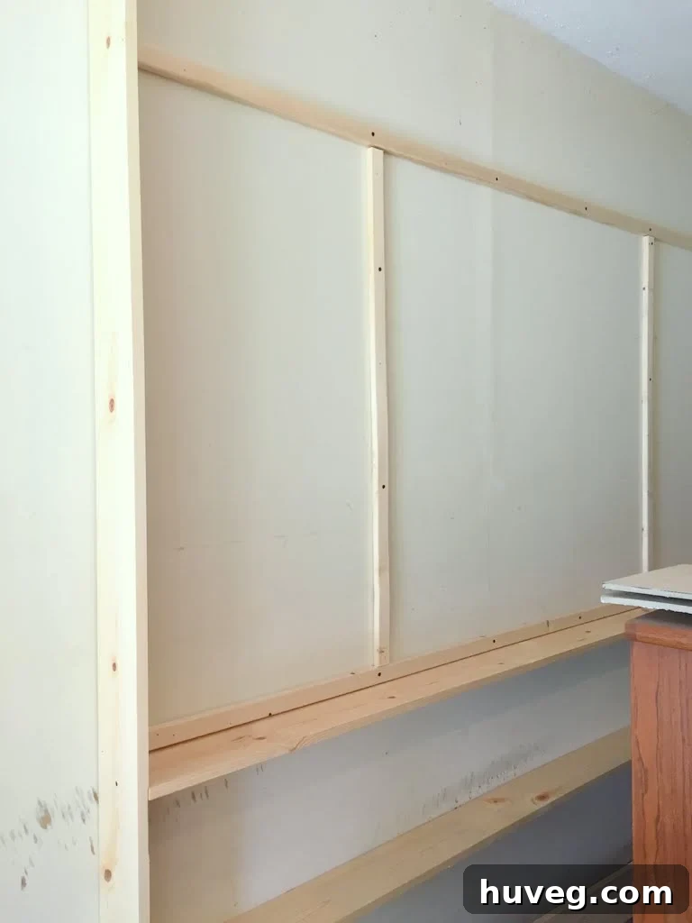 Installing wood planks for pegboard framing
