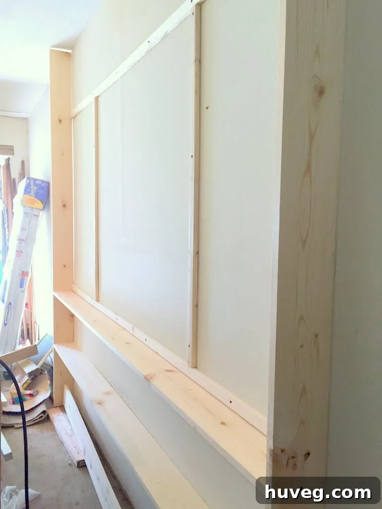 Framing out the wall for pegboard and shelves, showing detailed construction