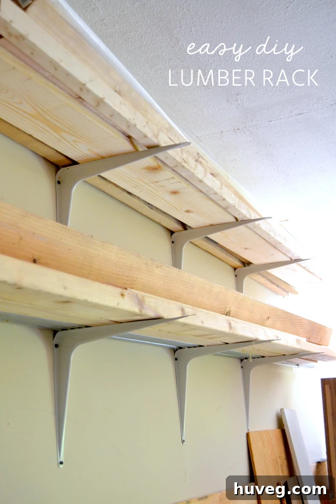DIY lumber rack constructed with heavy-duty shelf brackets in a garage workshop