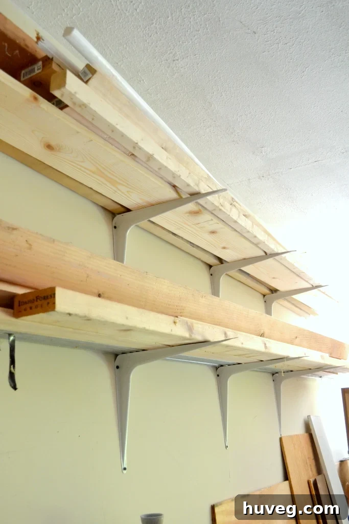 DIY garage lumber rack made with repurposed shelf brackets