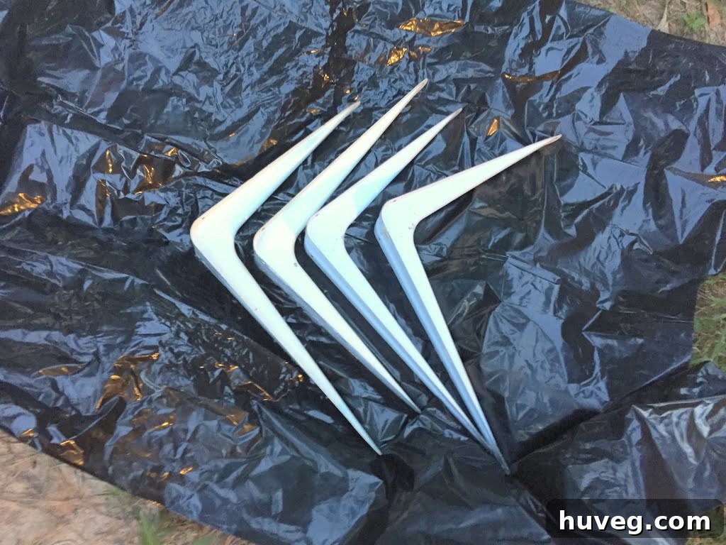 Spray painting old shelf brackets for a DIY lumber rack