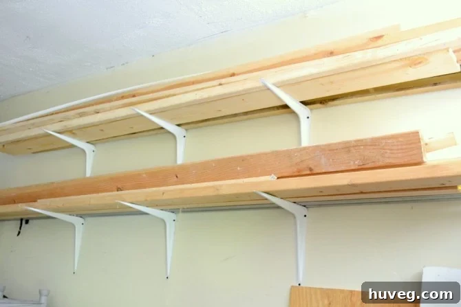 Loaded DIY lumber rack with various wood types and conduit